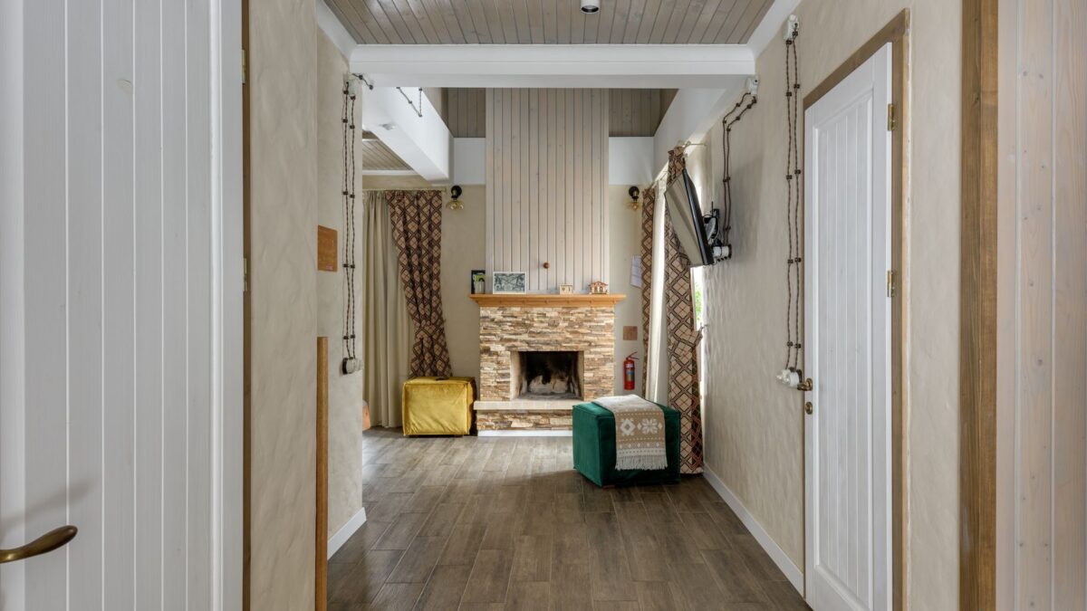 Warm and inviting chalet interior featuring wooden design and cozy fireplace setting.