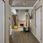 Warm and inviting chalet interior featuring wooden design and cozy fireplace setting.