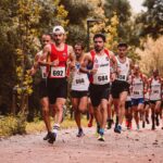A dynamic scene of male athletes participating in an outdoor marathon race.