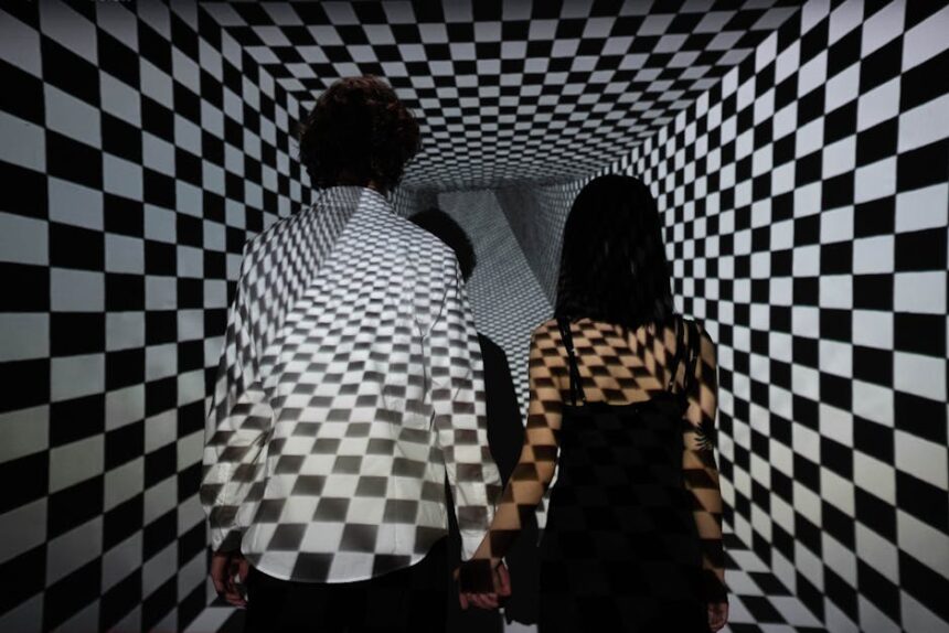 illuseum berlin - Couple walking in a checkerboard tunnel, creating an optical illusion of depth and