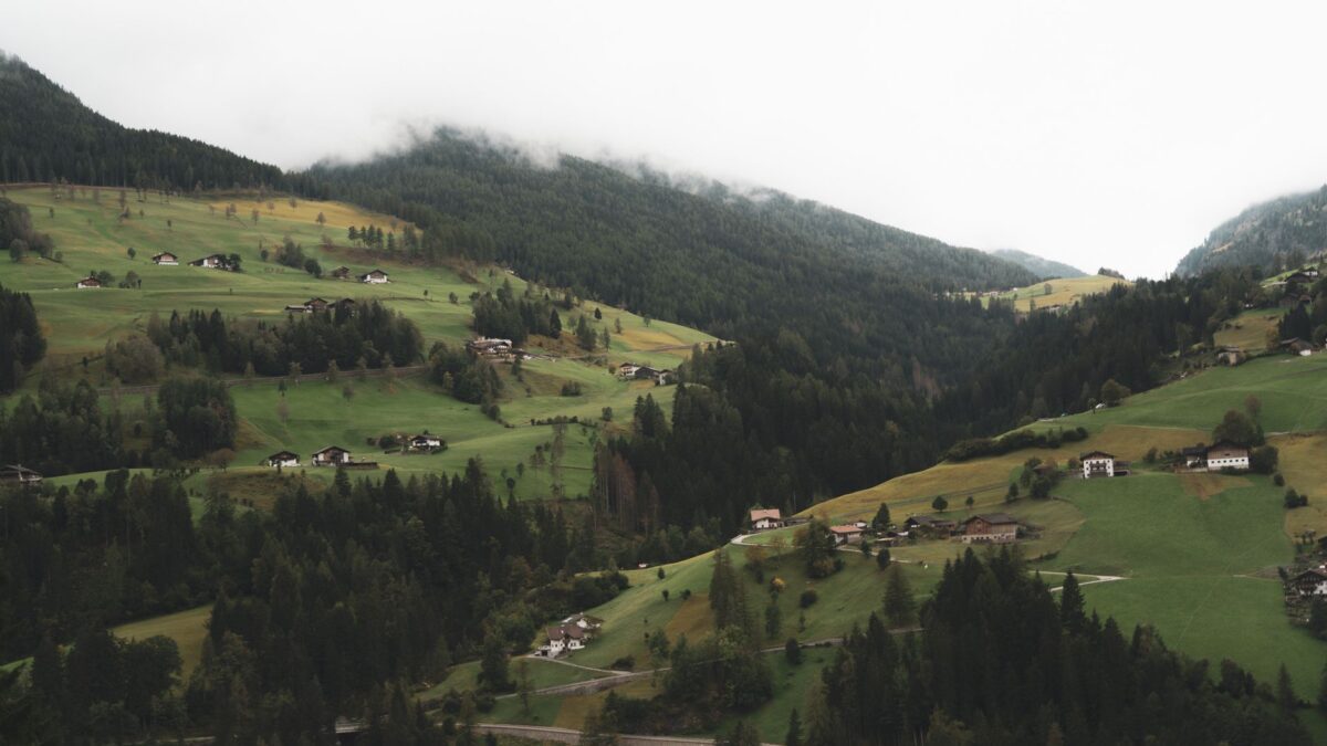 Einfamilienhaus in einer österreichischen Landschaft unter aufziehenden Gewitterwolken